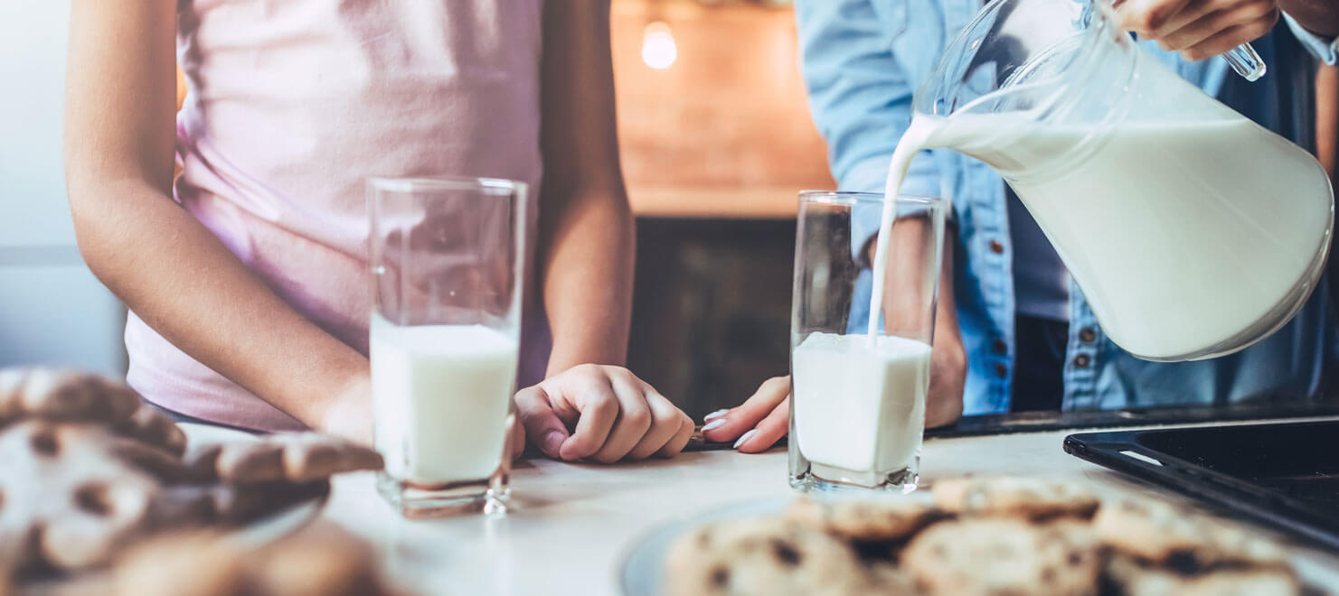 glasses of milk being poured